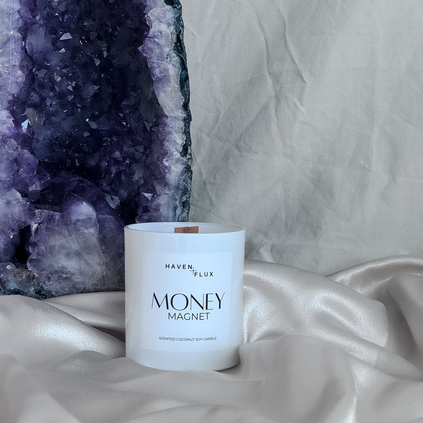 money magnet non-toxic, coconut soy, wood wick candle with amethyst rock behind it