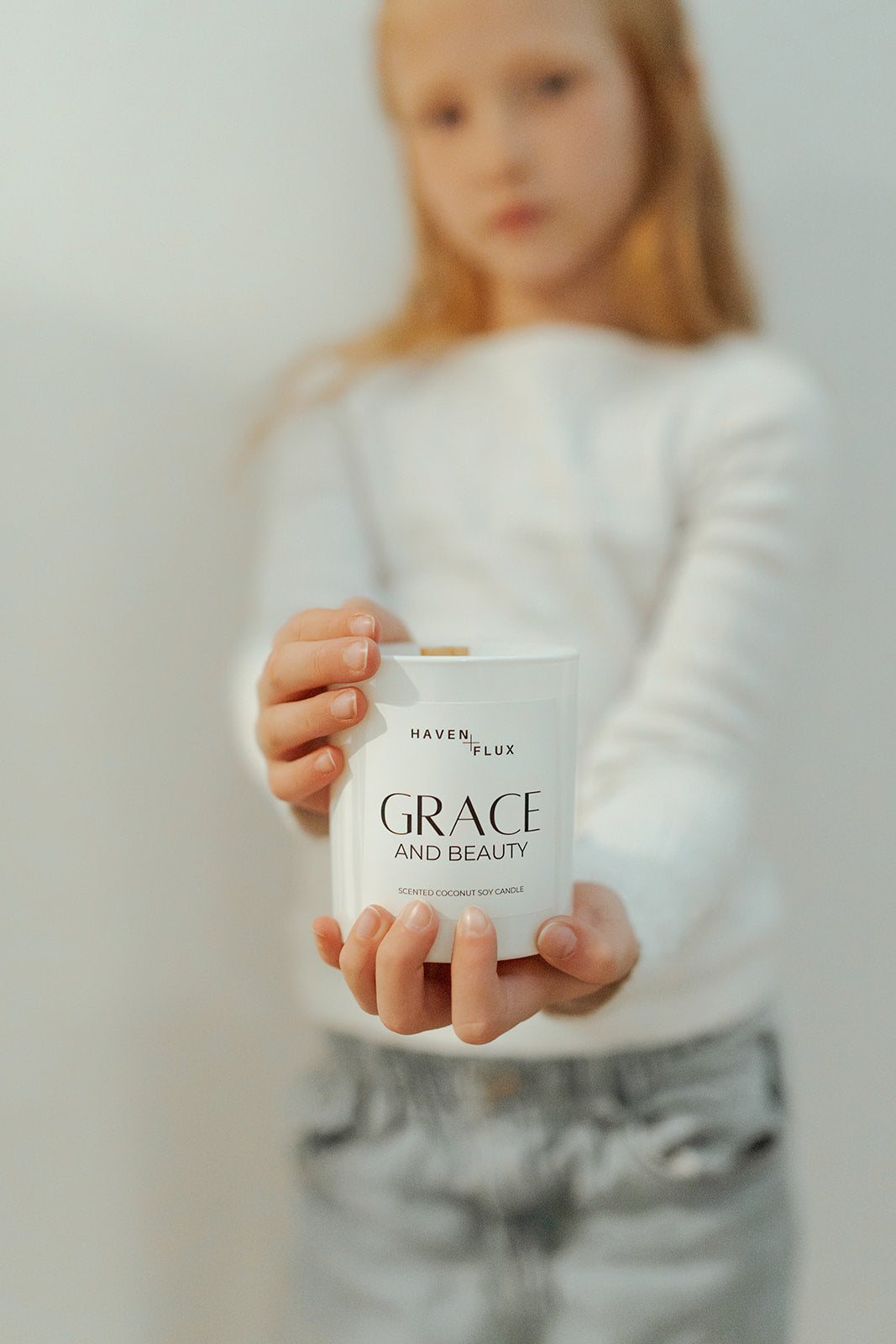 Grace Wooden Wick Candle featuring a luxurious blend of orange blossoms, dewy gardenia, and spiced vanilla scent notes. Crafted with high-quality, non-toxic ingredients, this candle embodies the essence of beauty and grace in its various forms, from delicate blooms to warm spices.