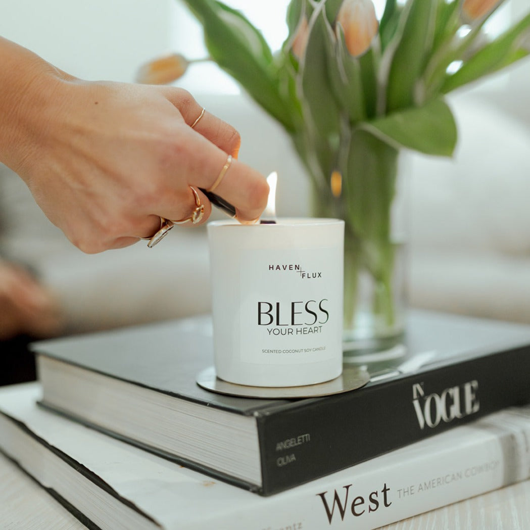 Bless Your Heart Wooden Wick Candle featuring a luxurious blend of fresh cut white blossoms, green tea, and Australian sandalwood scent notes. Crafted with high-quality, non-toxic ingredients, this candle captures the essence of sweet, silly moments, and the times you want to spill the tea.