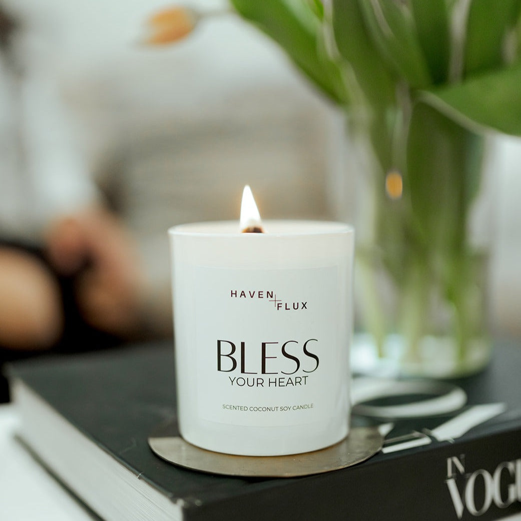 Bless Your Heart Wooden Wick Candle featuring a luxurious blend of fresh cut white blossoms, green tea, and Australian sandalwood scent notes. Crafted with high-quality, non-toxic ingredients, this candle captures the essence of sweet, silly moments, and the times you want to spill the tea.