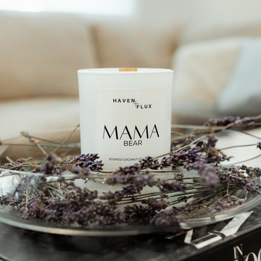 Mama Bear Wooden Wick Candle surrounded by lush lavender, symbolizing luxury and tranquility. Crafted with non-toxic ingredients and featuring scent notes of wild flowers, fresh lavender, and mountain air, it embodies the essence of nature and relaxation.